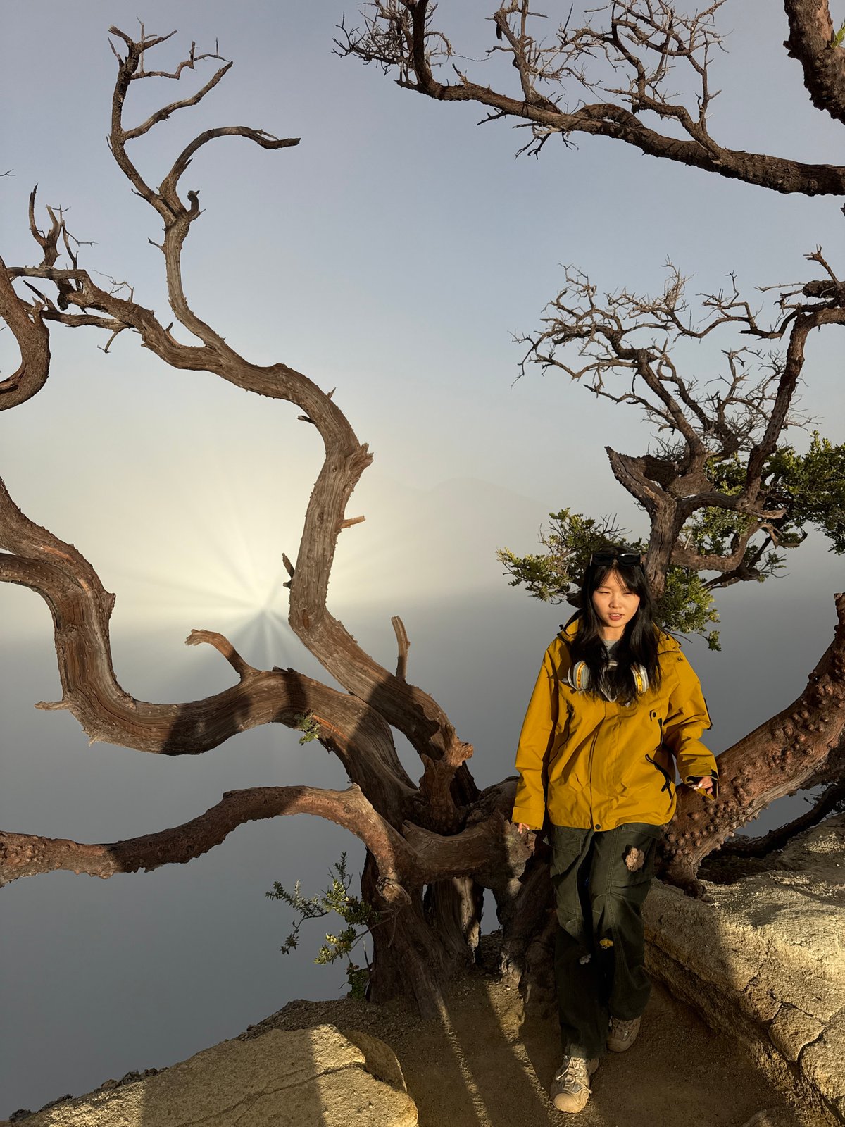 Tourists in gas masks explore active Indonesian volcano at sunrise