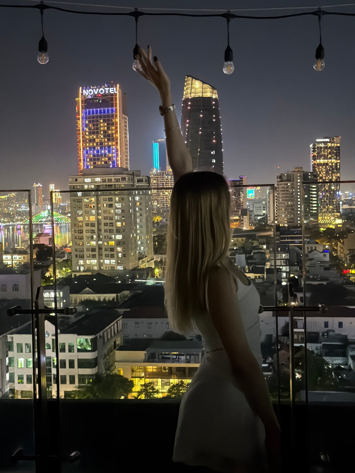Rooftop moment overlooking Đà Nẵng city skyline at night