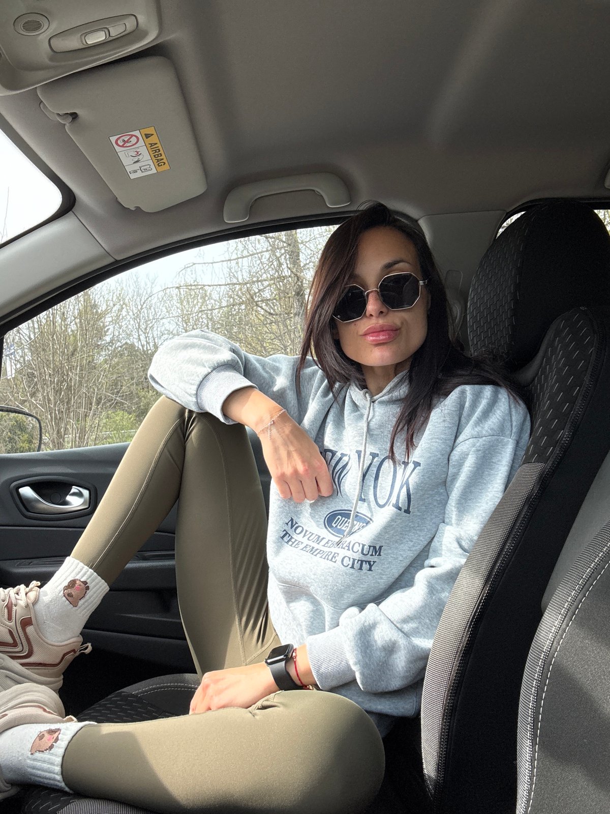 Woman in Empire City hoodie spotted in car passenger seat