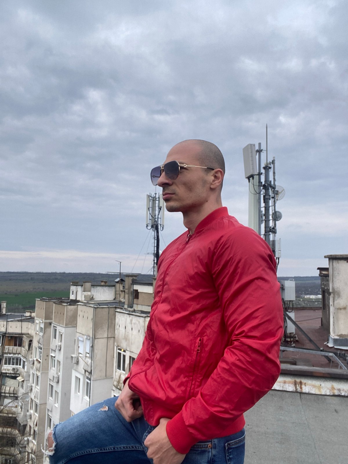 Tattooed man and dog photographed across Pleven rooftops