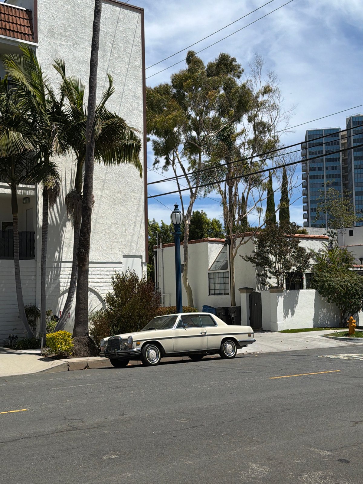Vintage white Mercedes parked on a Long Beach residential street
