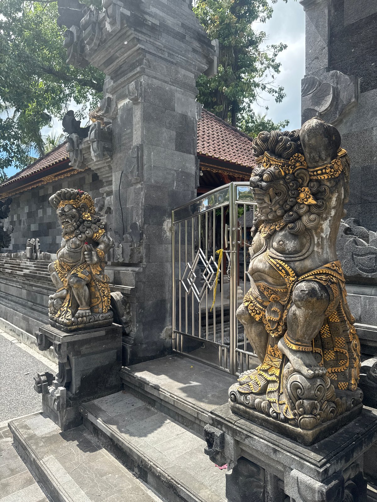 Tourist documents Balinese temple statues and coastal views in Nusa Penida