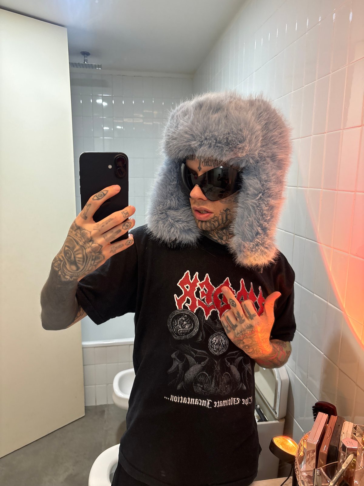 Tattooed individual photographed in Buenos Aires bathroom, bus departure recorded