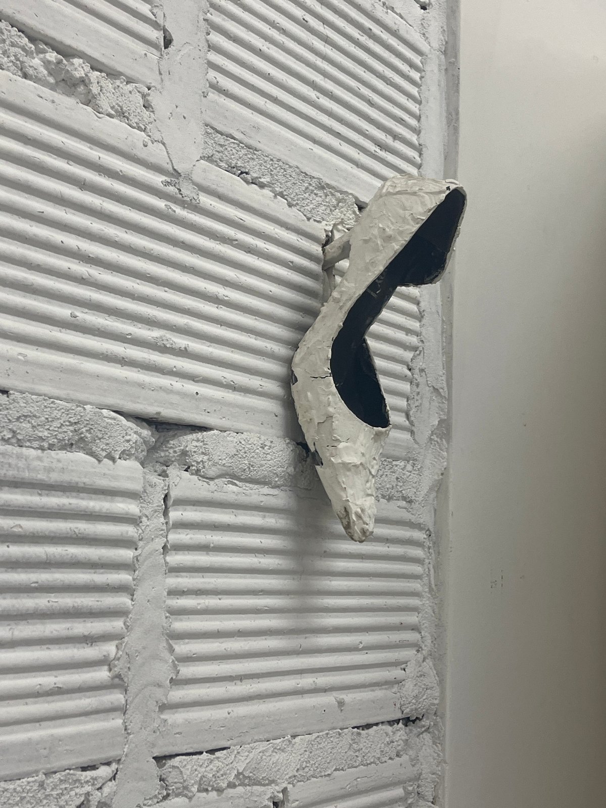 Objects observed against white brick surfaces in Buenos Aires