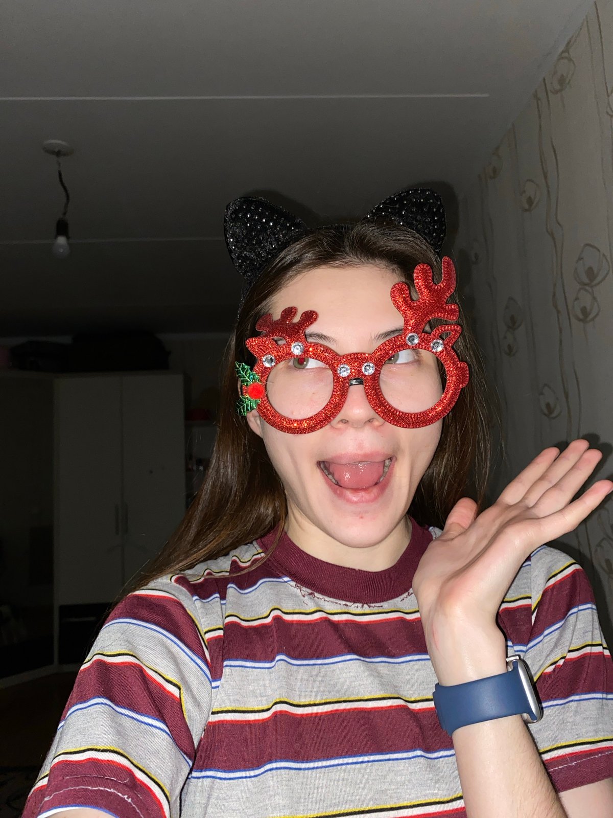 Young person takes playful selfies with novelty accessories in Votkinsk