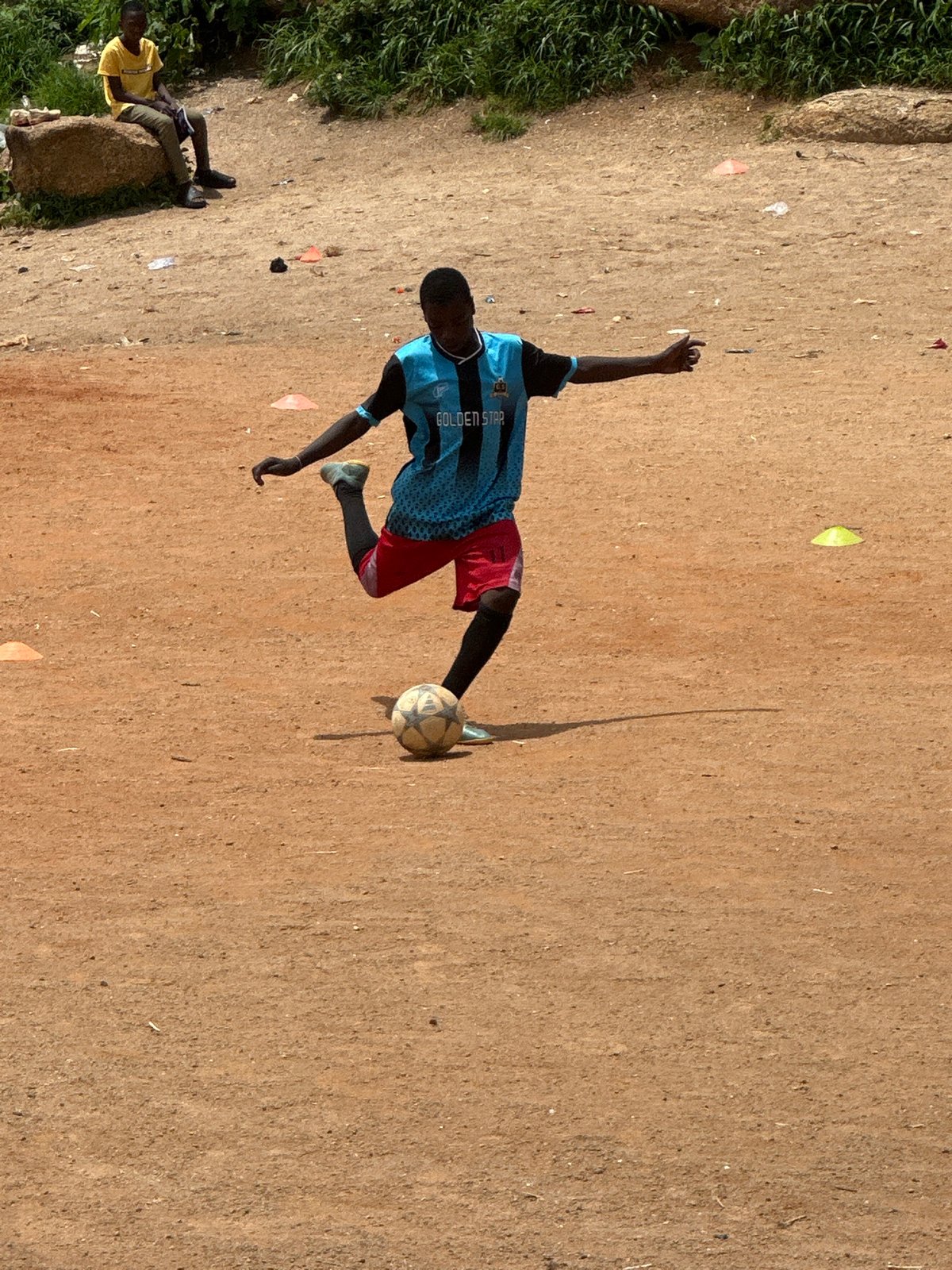 Pickup soccer on a rocky dirt field in Jos, Nigeria