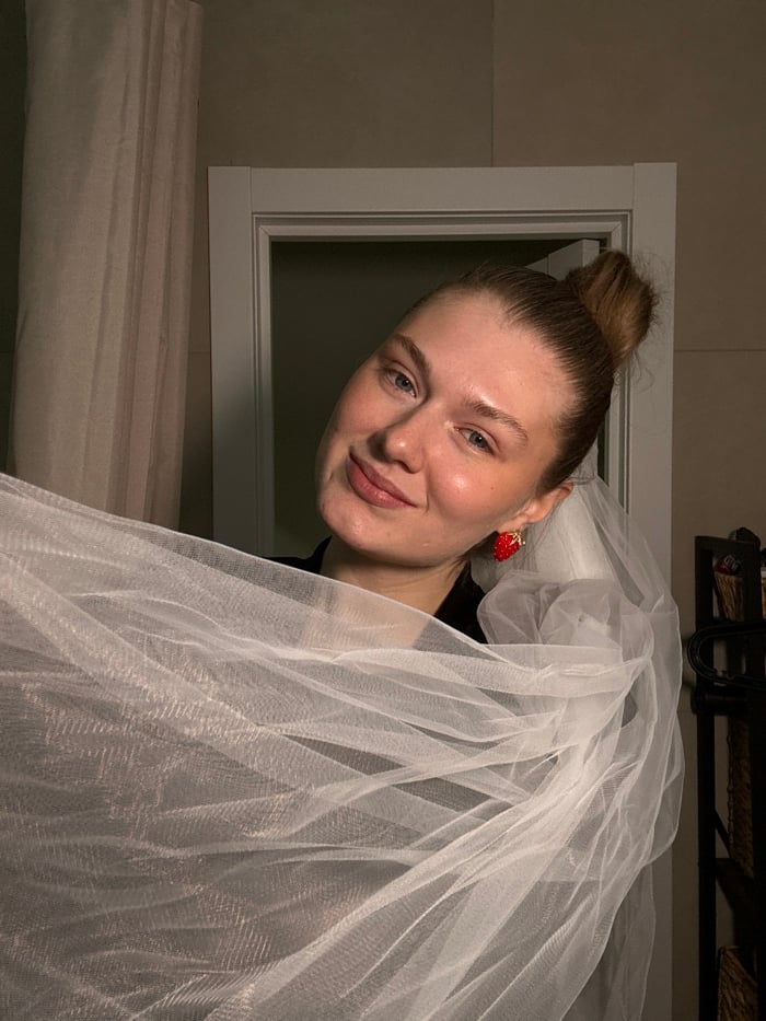 Woman photographs selfie session with strawberry earrings in Kazan