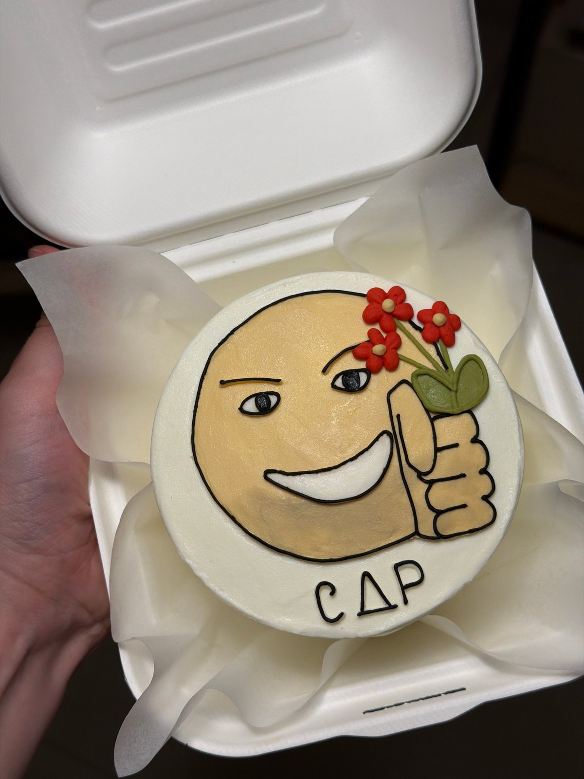 Custom emoji cake spotted in Tel Aviv takeout container