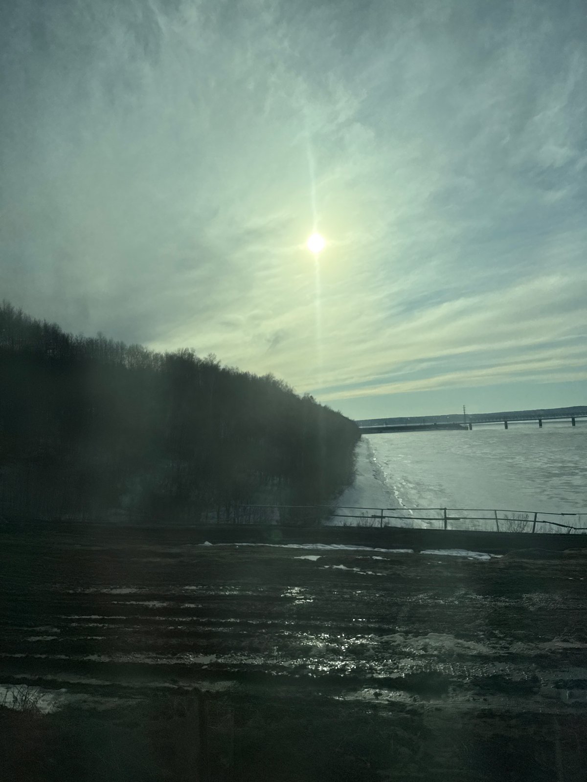 Heavy construction machinery active along frozen river in Perm