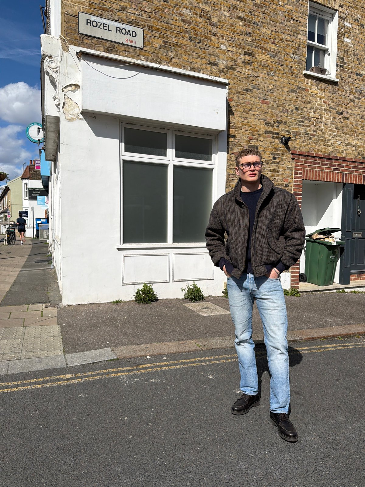 Person stands on Rozel Road in London wearing casual attire