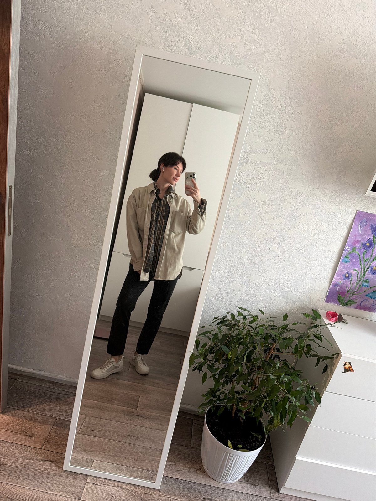 Woman takes morning mirror selfies in Perm apartment