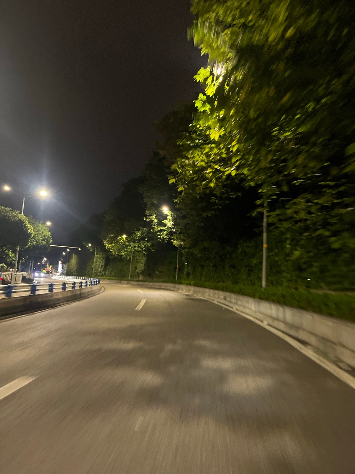 Nighttime drive through wet Jiulongpo District streets documented