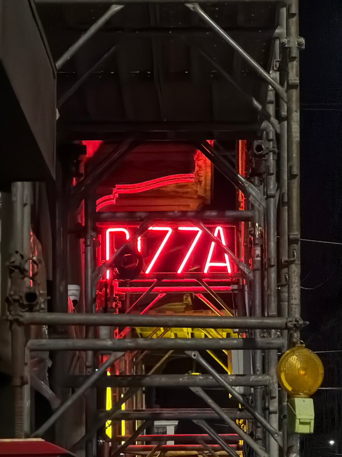 Neon signs and movie billboards light up a Milan night
