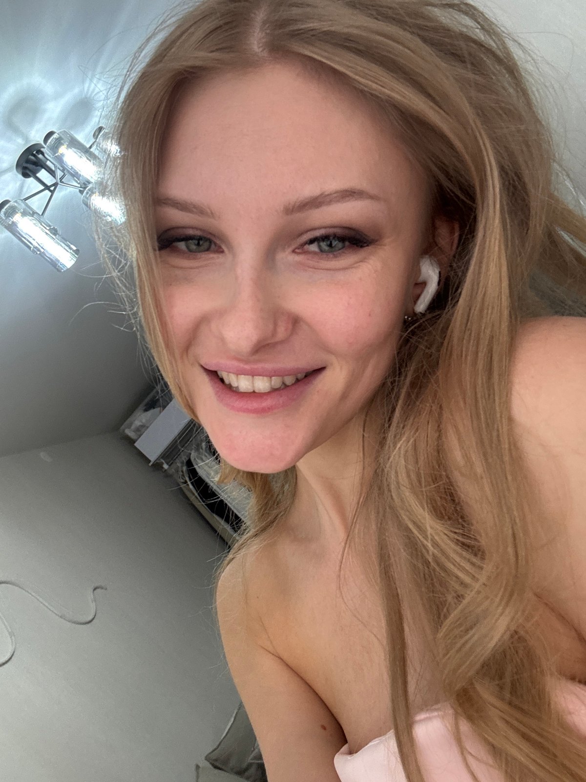 Woman takes selfie session in pink dress, Perm apartment