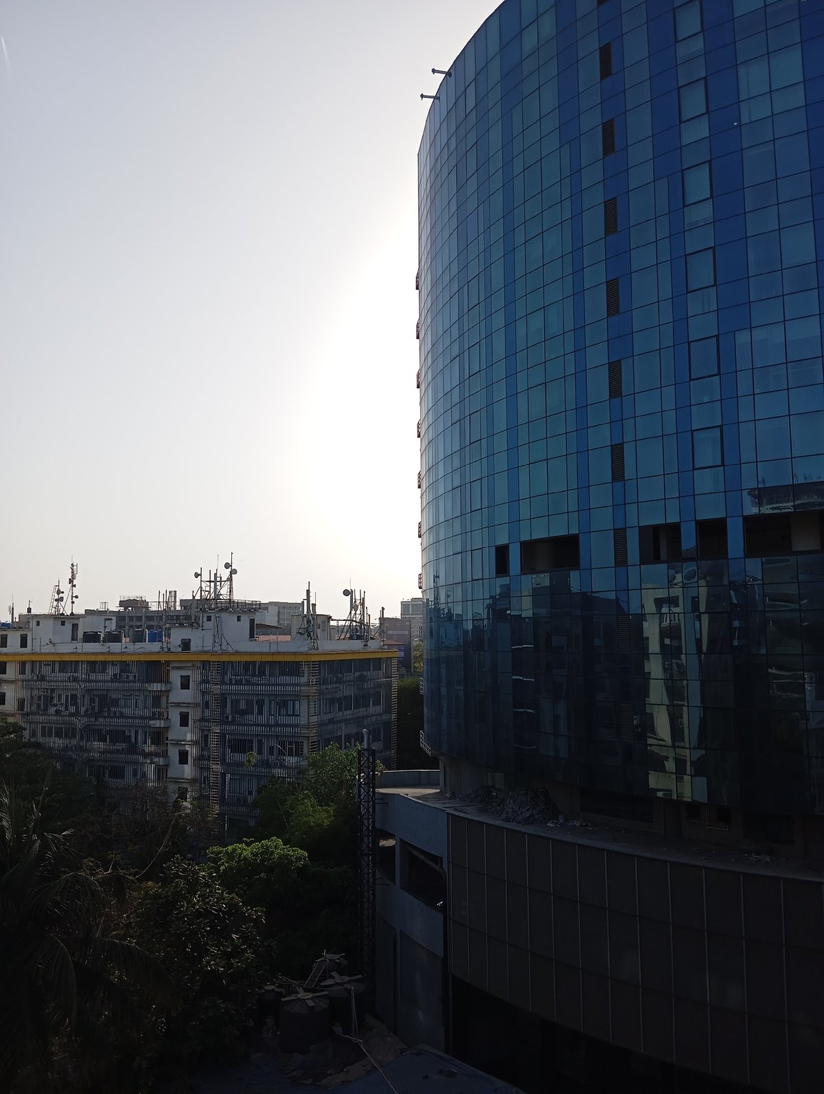 Modern glass building photographed in Mumbai urban landscape
