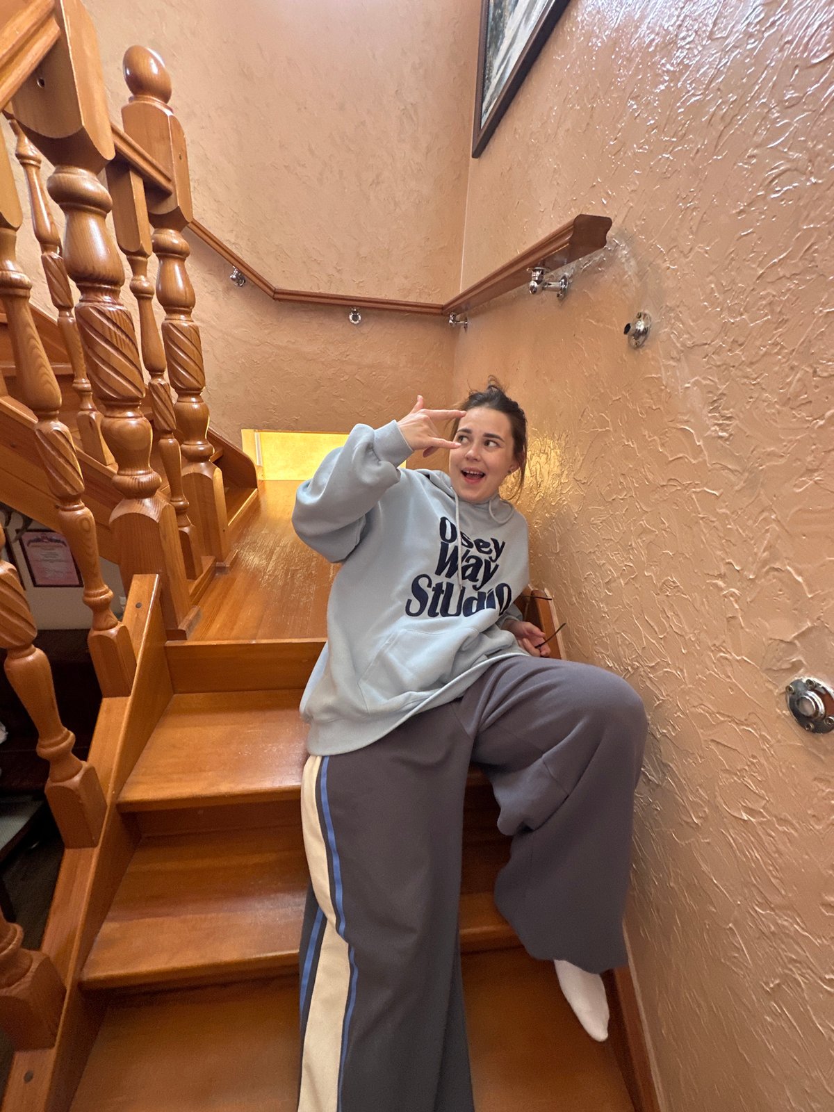 Casual indoor photo session on wooden stairs in Ilyinsky