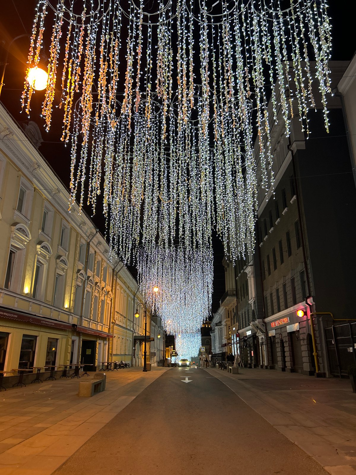 Moscow street lit by overhead white light canopy