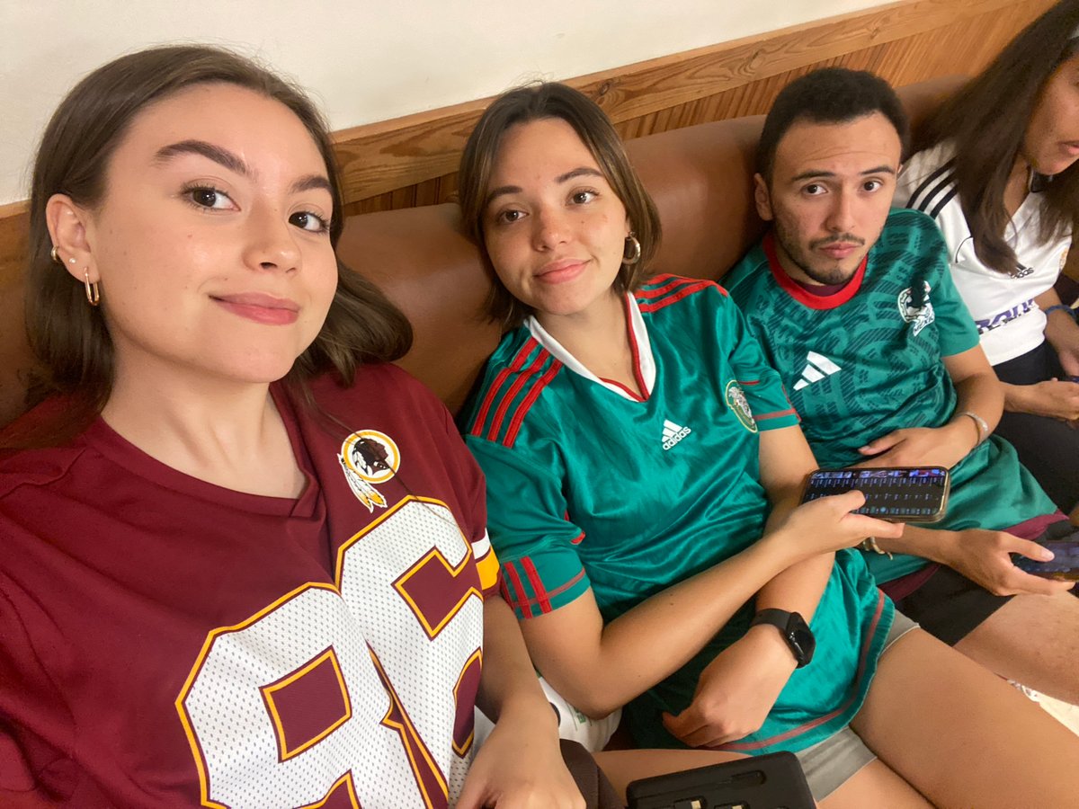 Casual couch hangout in Washington Township, sports jerseys on