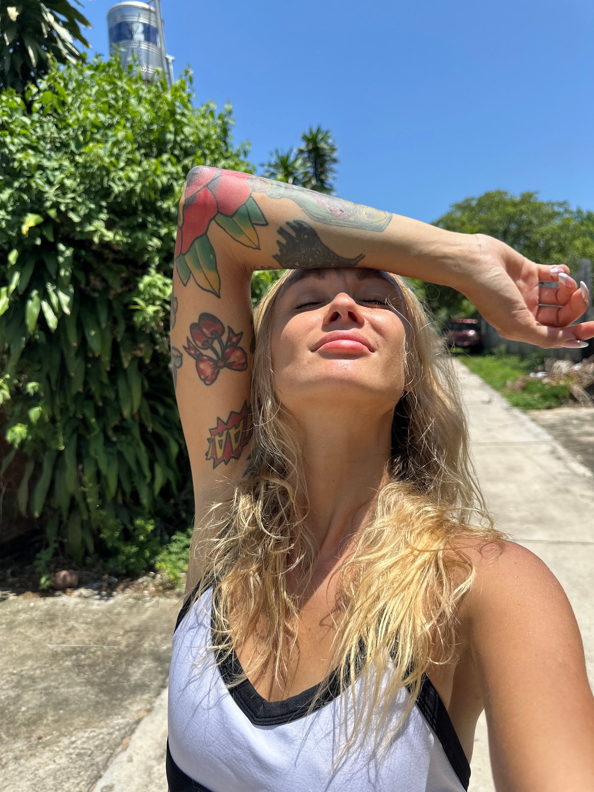 Tattooed blonde woman photographed multiple times in Mũi Né