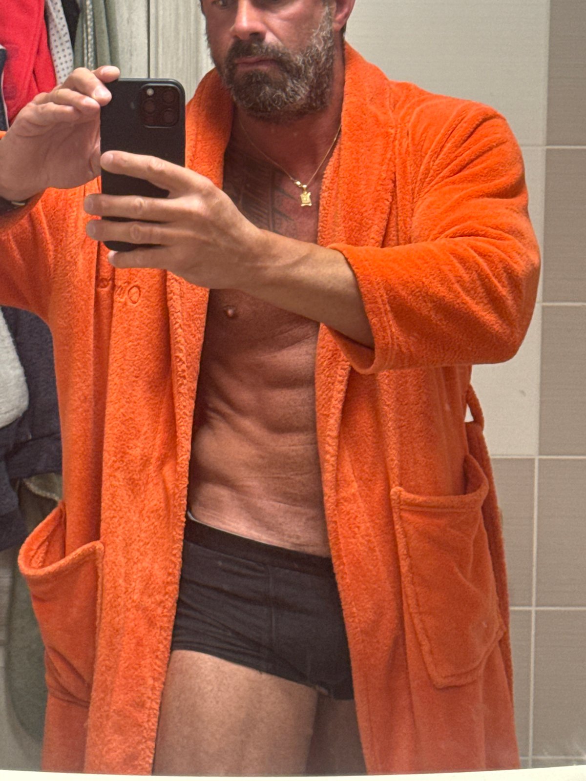 Man Takes Mirror Selfie in Orange Robe in Belgian Town