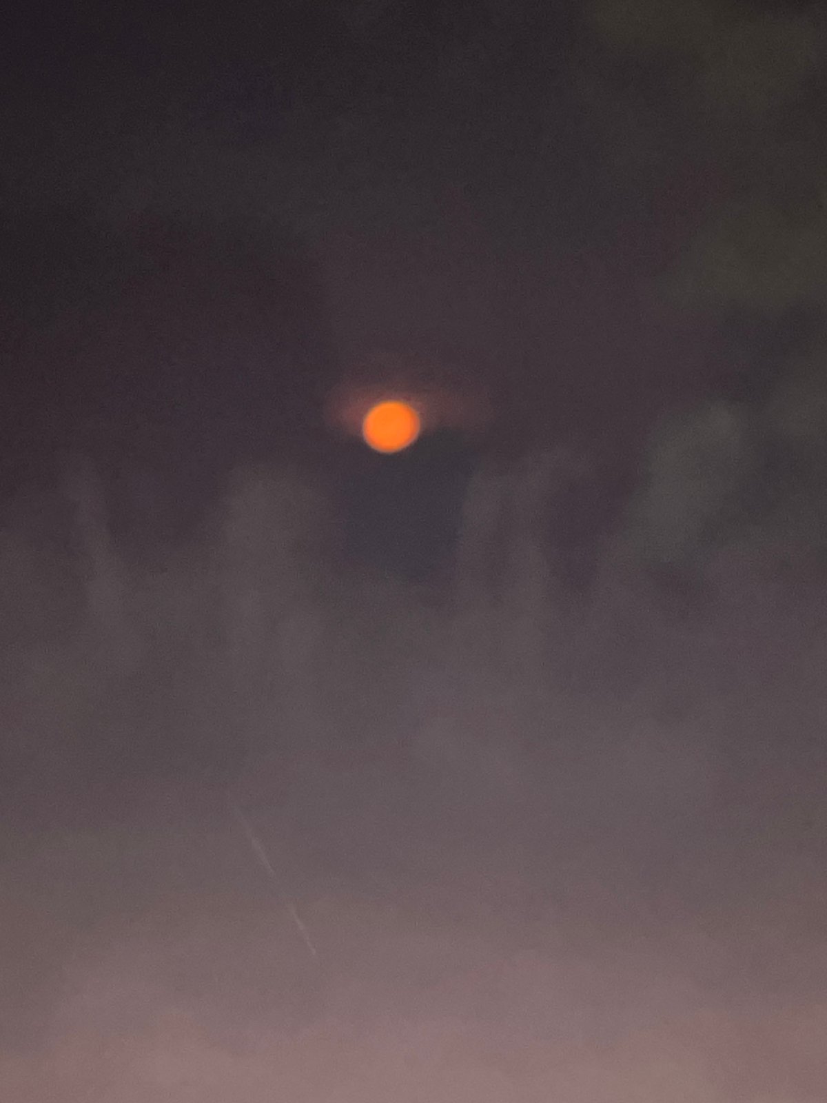 Obscured orange orb observed in low-light conditions