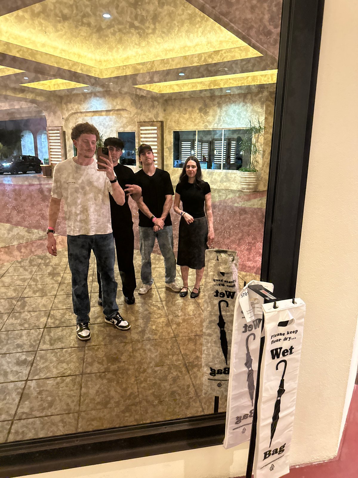 Group of four photographed near mirrored wall at Seminole Reservation