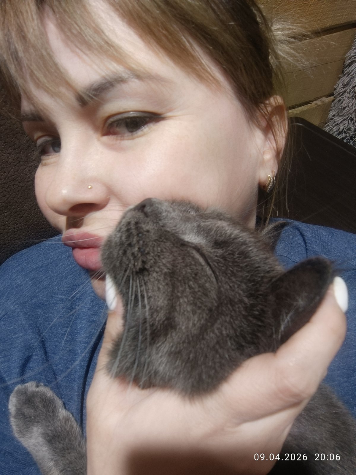 Woman cuddles gray cat during quiet afternoon in Chaikovsky