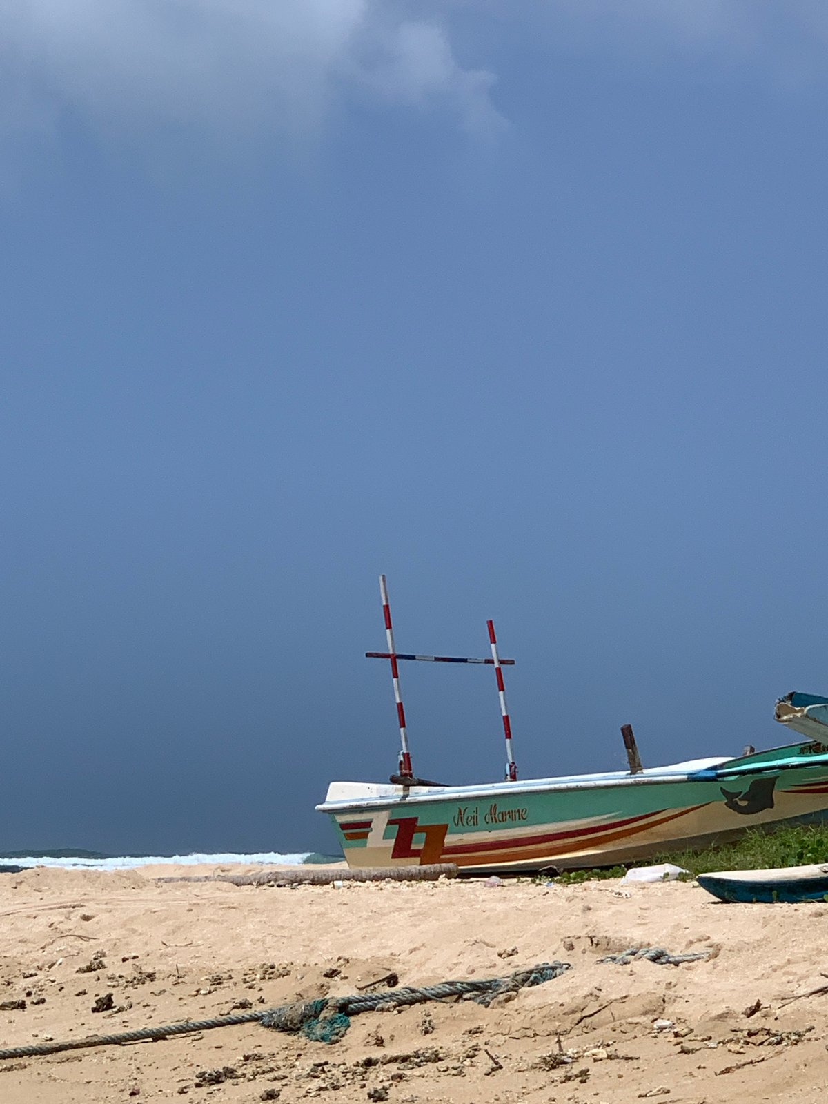 Fishing boats and surf culture share the Weligama shoreline