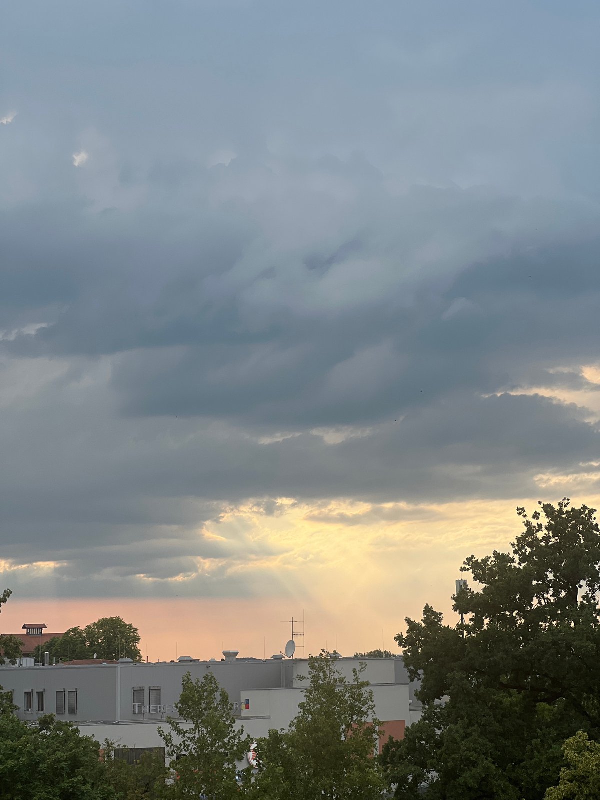 Rooftop views and cloudy skies over Straubing on a summer afternoon