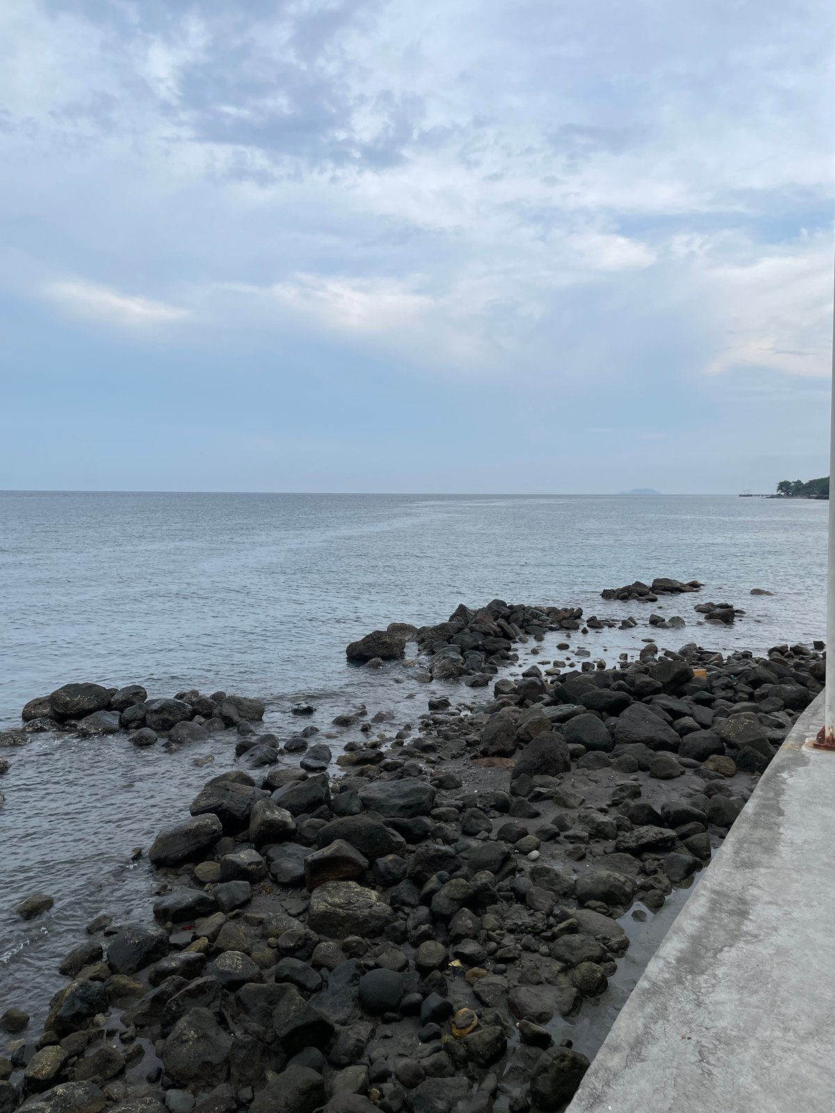 Morning coastal views captured along Bacong seawall under cloudy skies