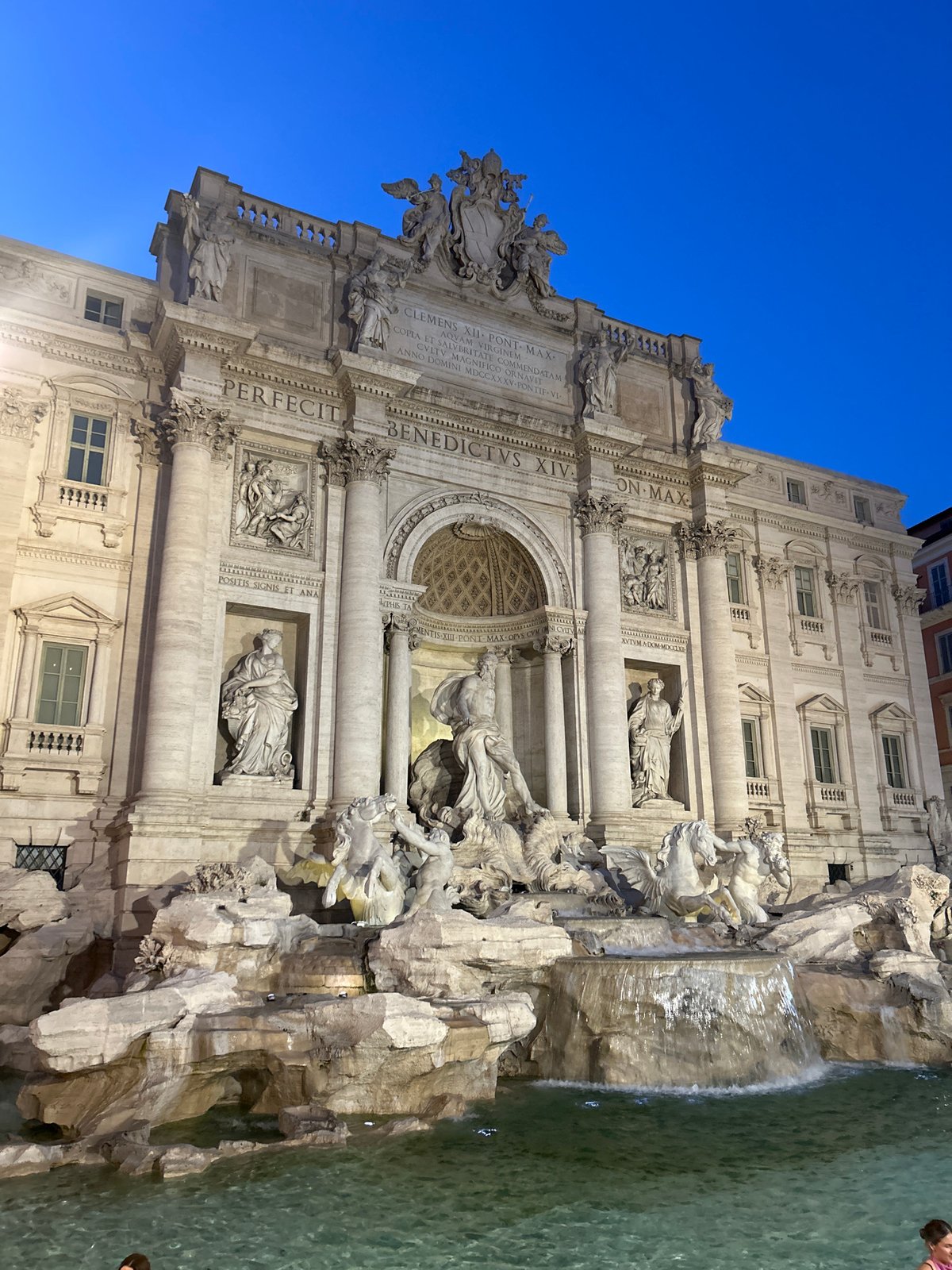 Trevi Fountain glowing under artificial lights at night
