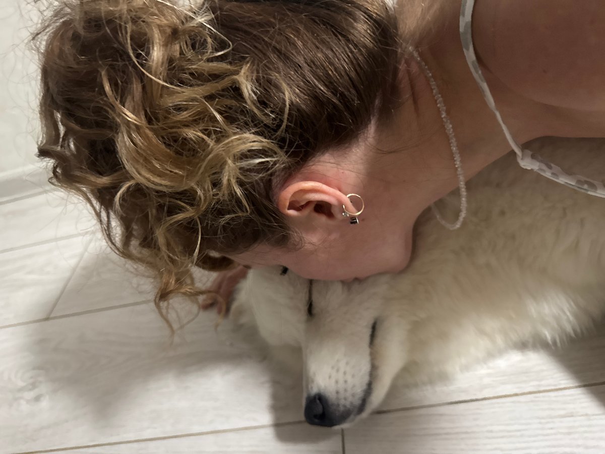 Woman and white Samoyed dog captured in intimate moments