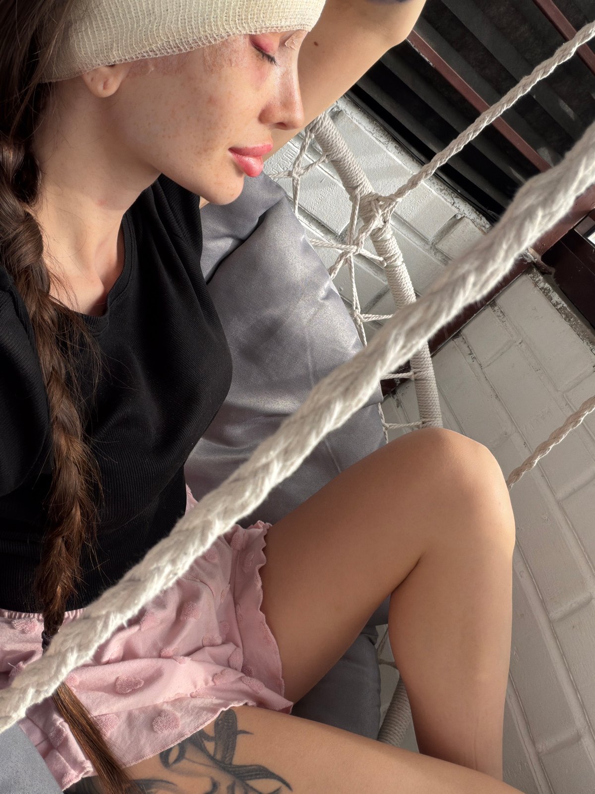 Person reads Russian book while relaxing in hammock, Saint Petersburg