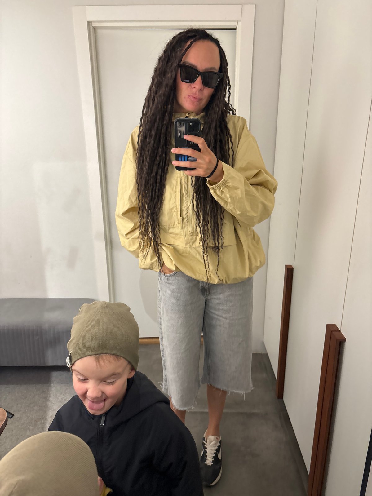 Woman and child take playful mirror selfies in Chaikovsky