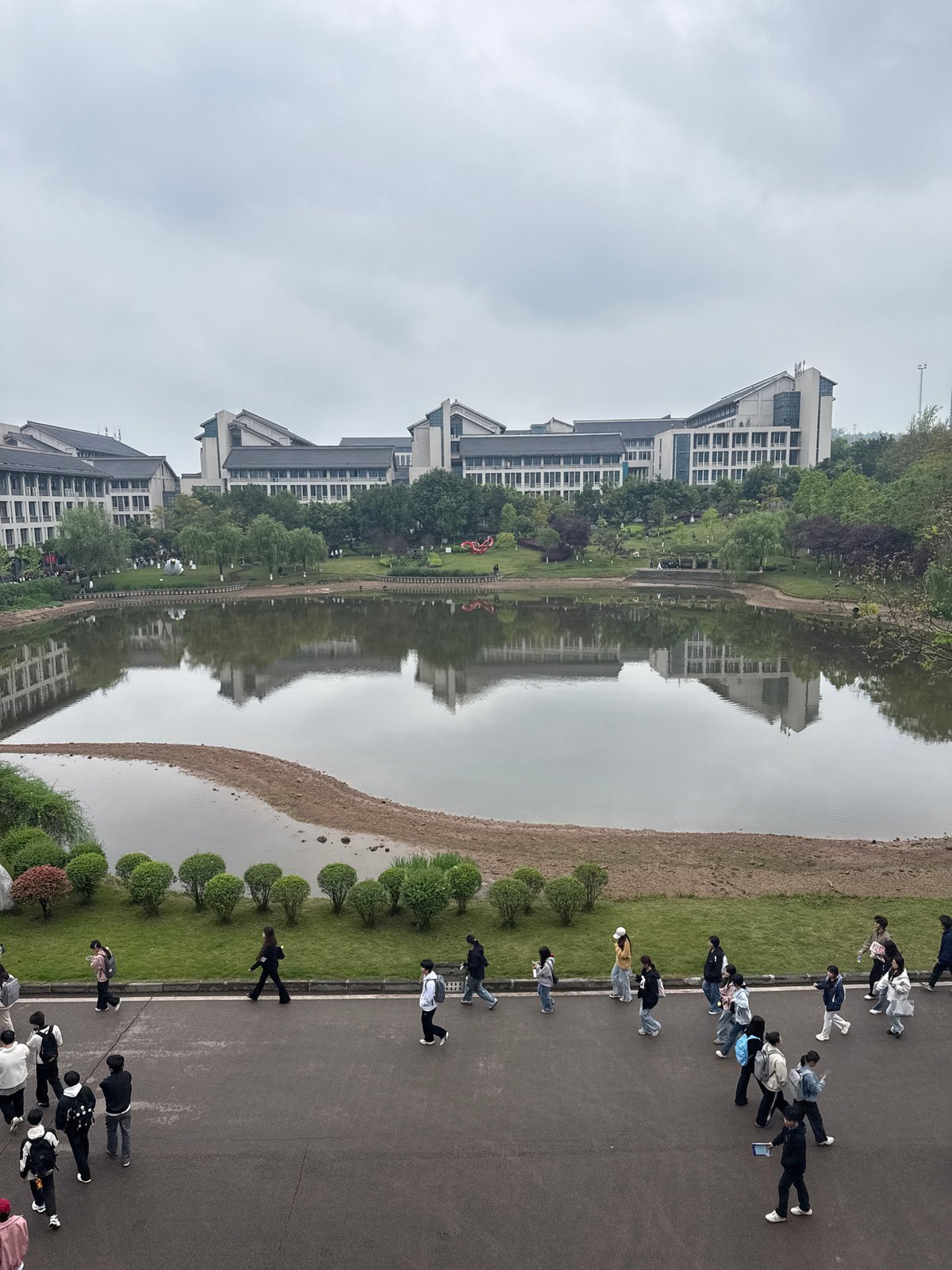 People stroll waterfront walkway in Jiangjin China