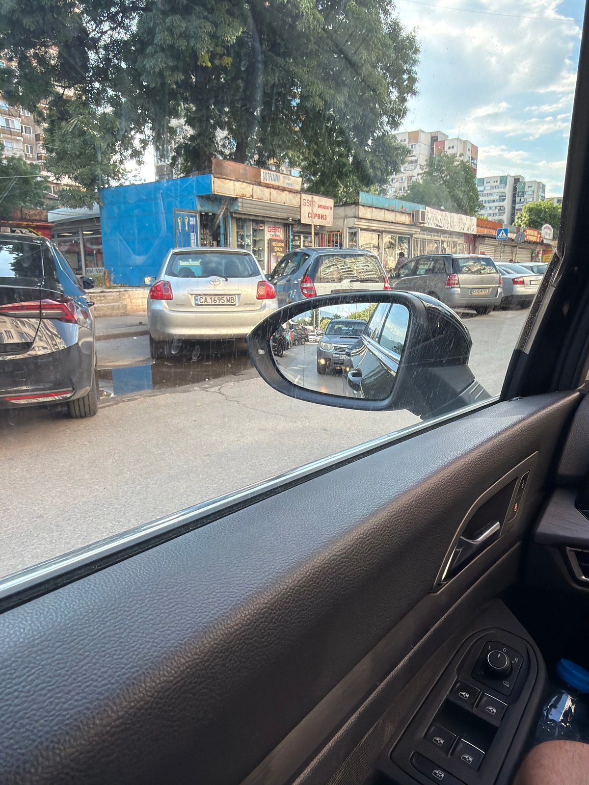 Car journey documented through Sofia streets, passenger photographed