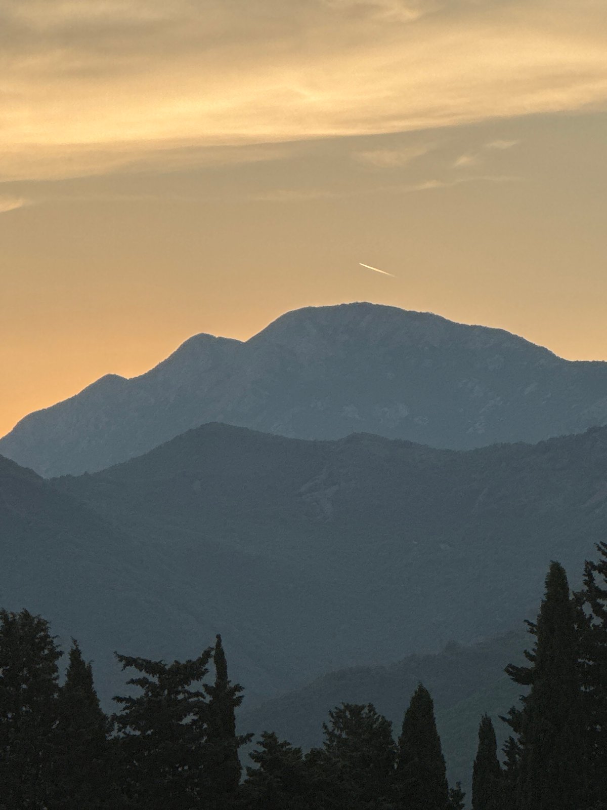 Waterfront sunsets, mountain views, and a cruising ship at dusk