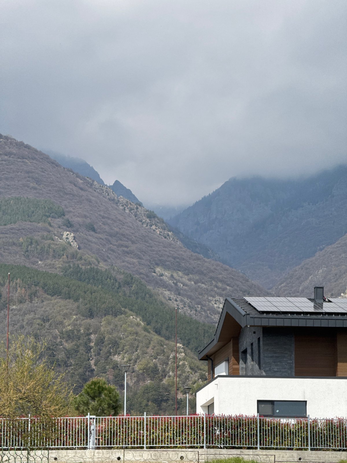 Person in athletic wear walks paths near Bulgarian mountain homes