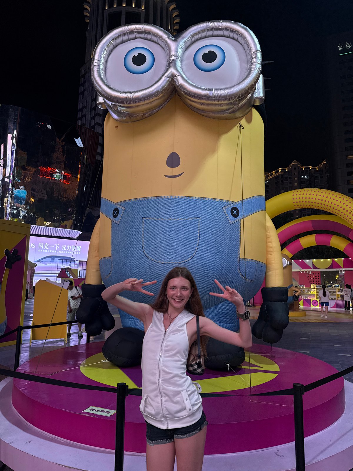 Tourists pose with giant Minion display in nighttime Shanghai