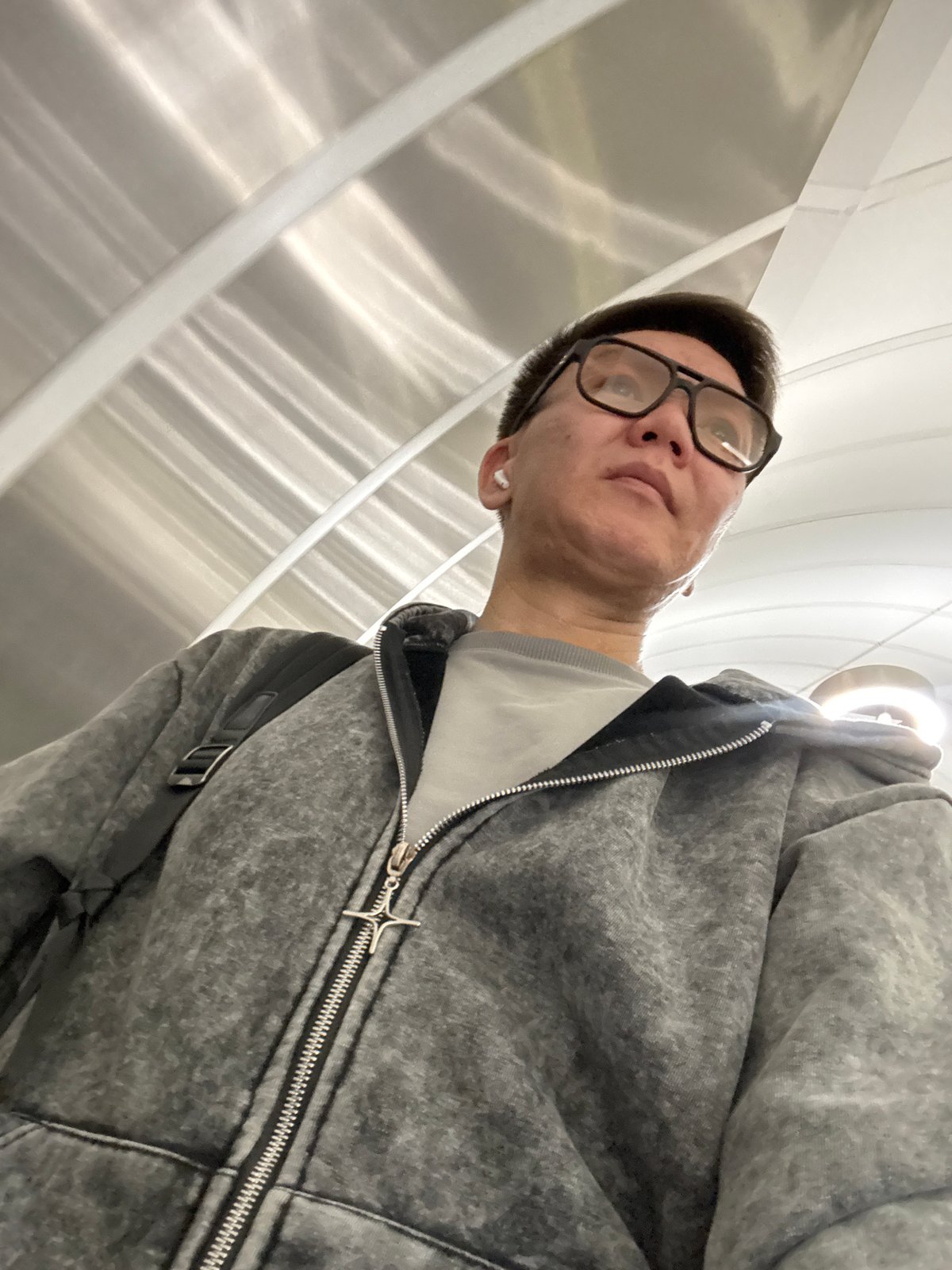 Man documents Moscow architecture selfie session in urban plaza