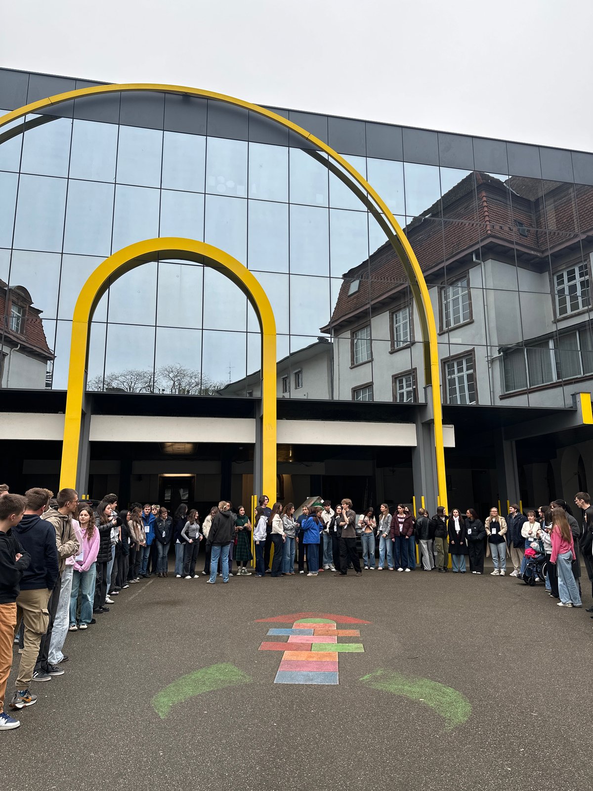 Teenagers form circle, clap outside Strasbourg building