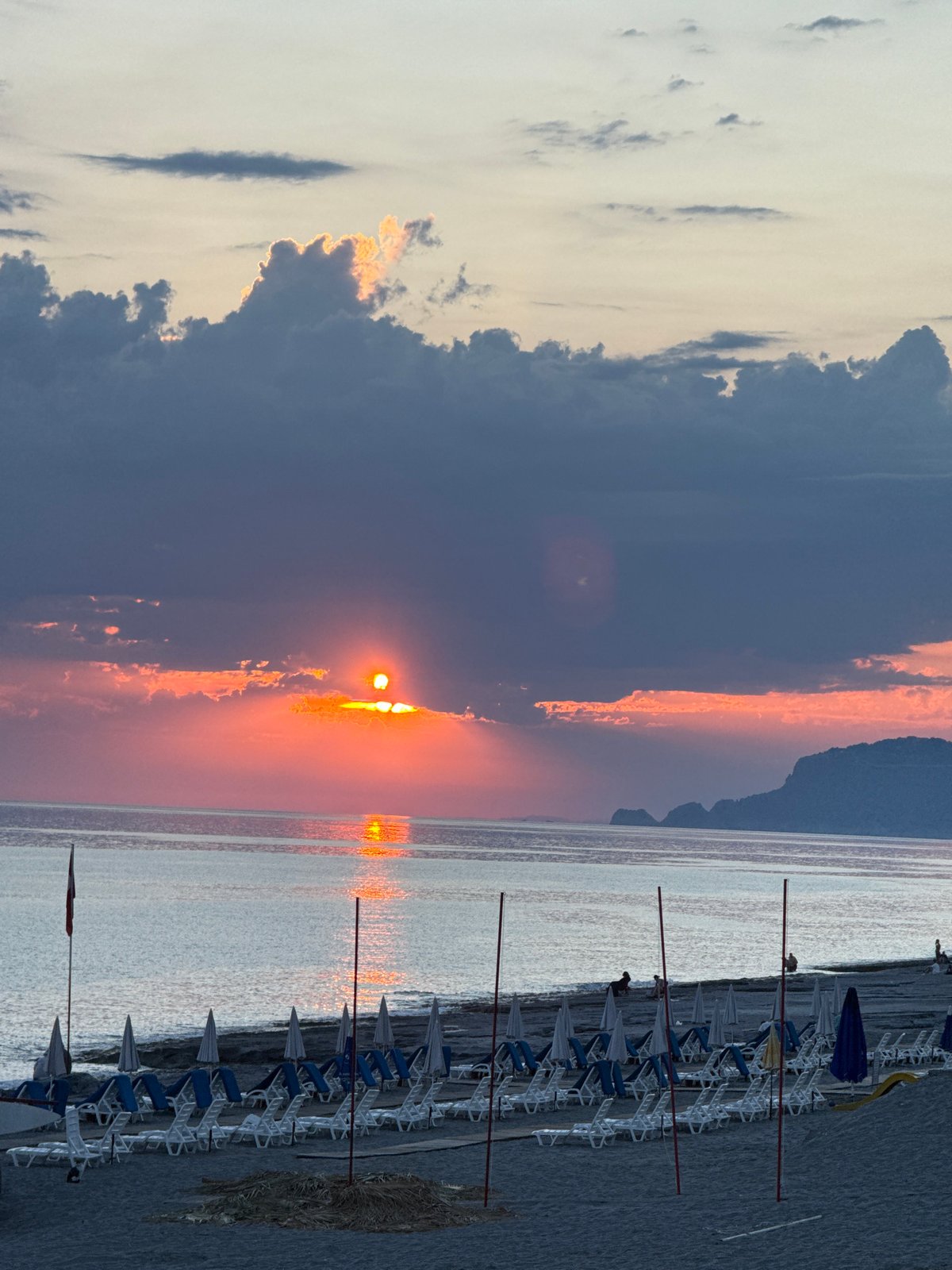 Sunset captured by multiple witnesses at waterfront beach