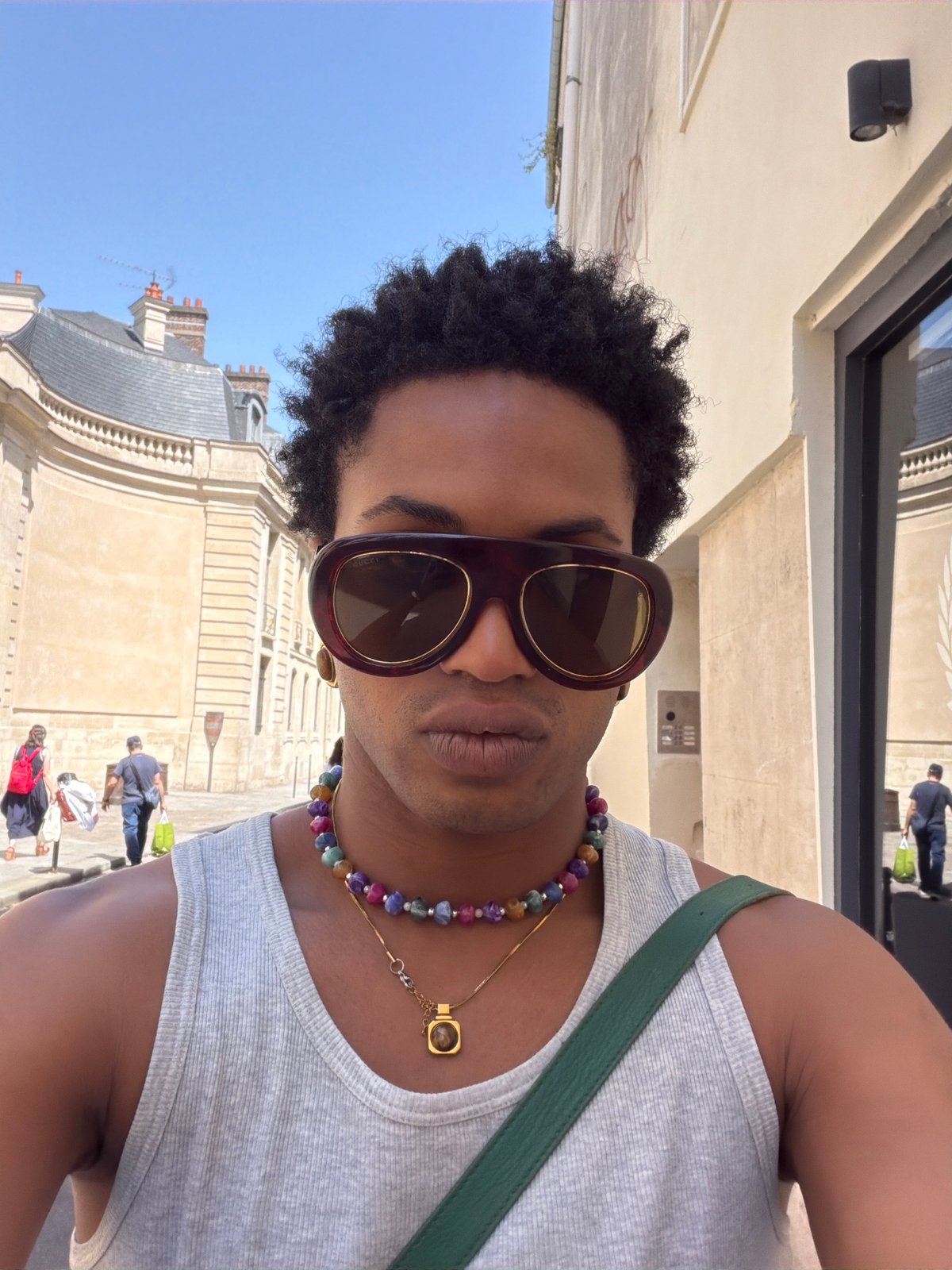 Person photographs self near Supreme shopping bags in Paris