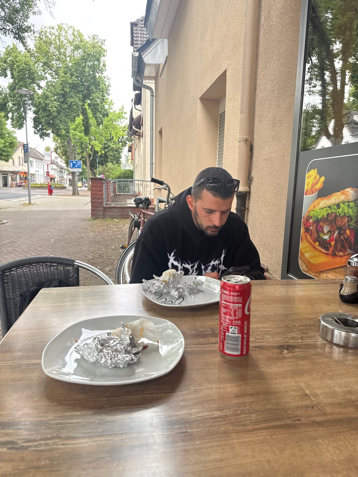Man sits at table in Hattersheim during overcast day