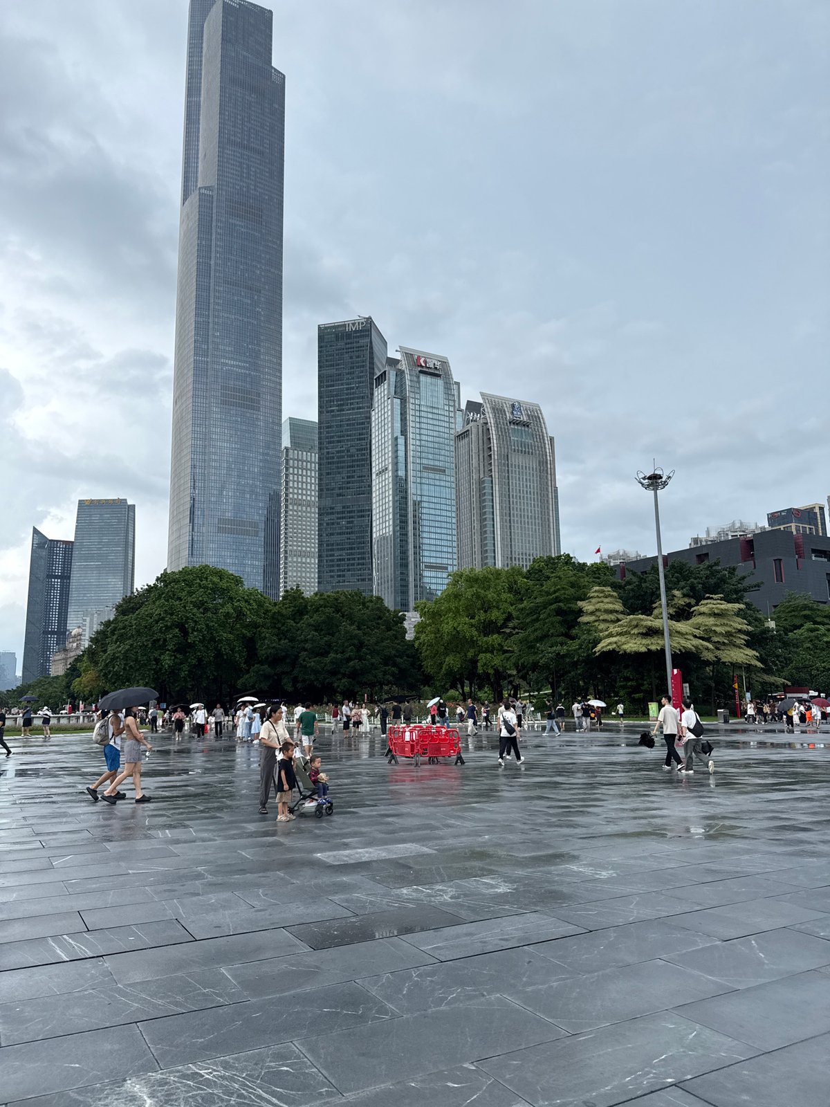 Rainy morning crowds fill Canton Tower plaza in Guangzhou