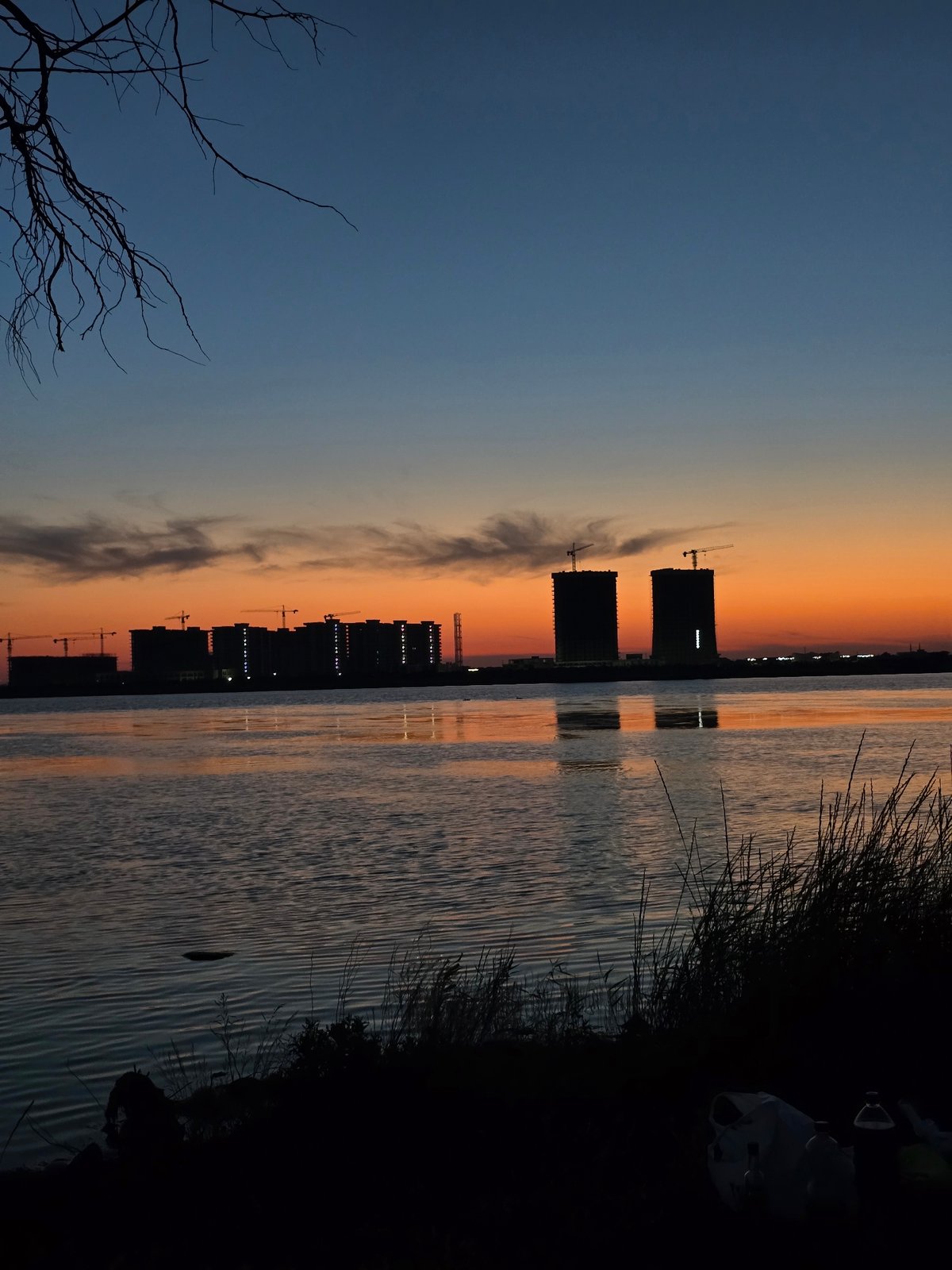 Sunset over Yevpatoriya waterfront, small fire in the reeds