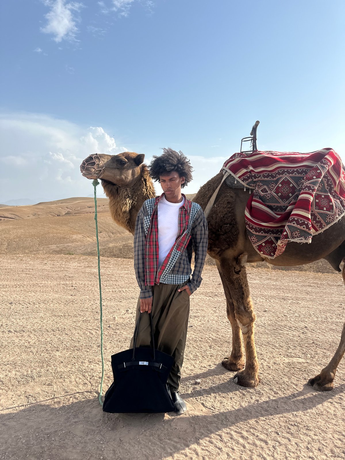 Tourists enjoy camel tour experience in Sidi Badhaj Morocco