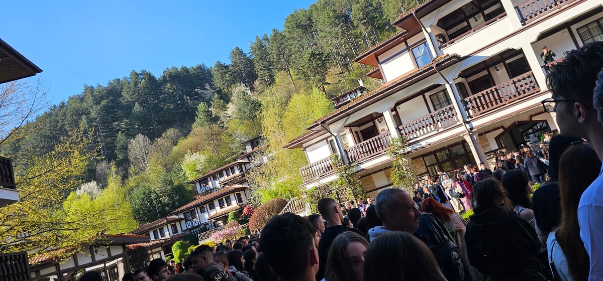 Large crowd gathers outdoors in hillside Devin, Bulgaria