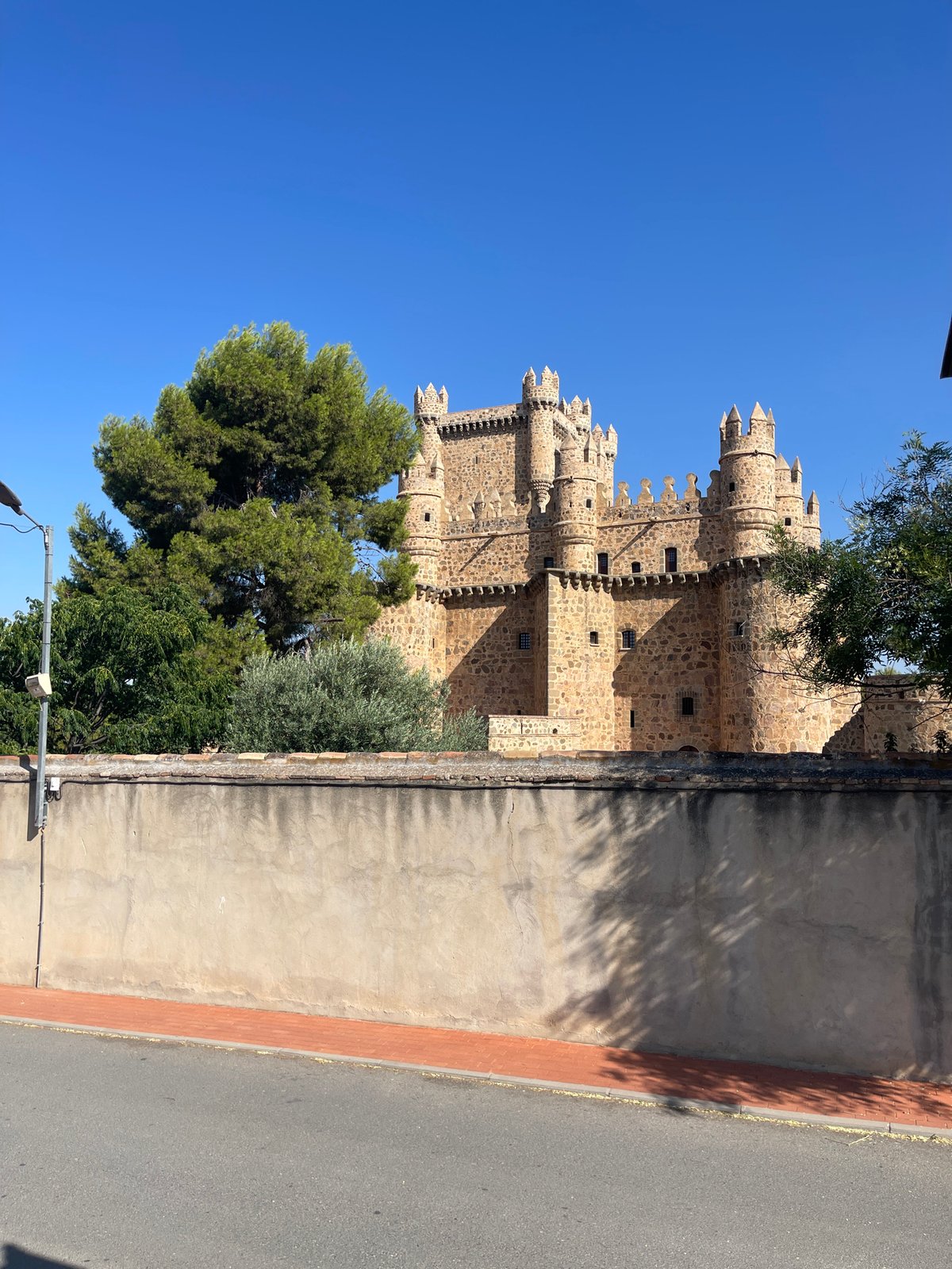 Guadamur's medieval castle, church, and chapel on a clear morning