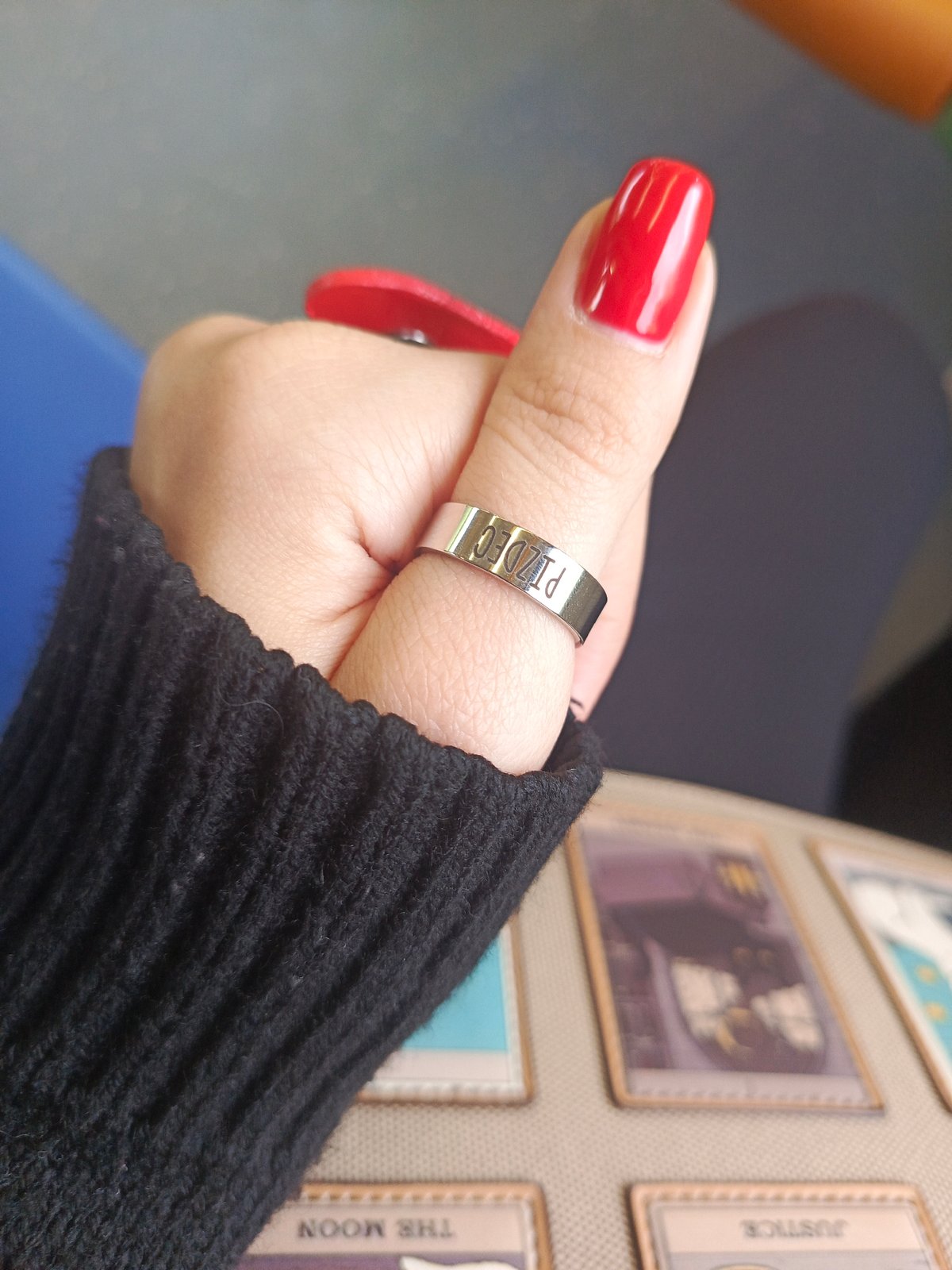 Train passenger displays distinctive jewelry and red nails in Russia